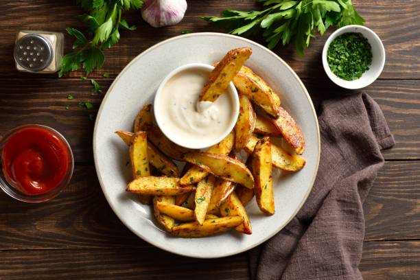 istock Baked potato wedges with sauce 1761636127