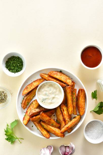 istock Oven baked potato wedges with sauce 1761636164