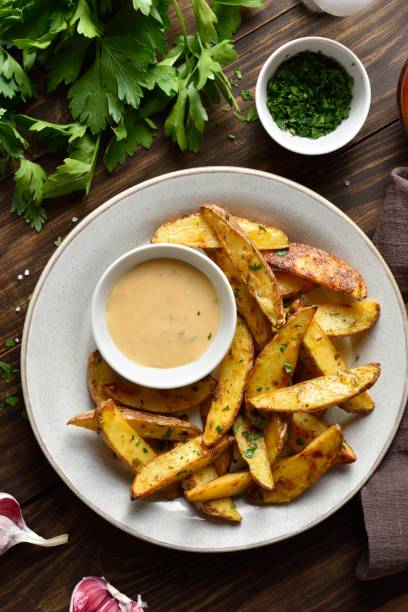 istock Baked potato wedges with sauce 1761636877