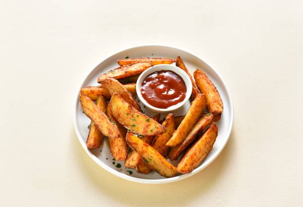 istock Oven baked potato wedges with sauce 1761636888