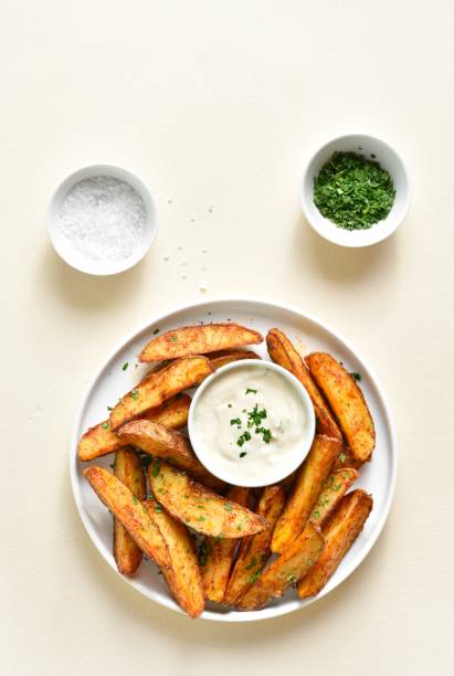 istock Oven baked potato wedges with sauce 1761636889