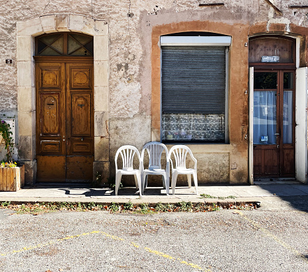 Three plastic chairs on the street