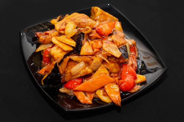 istock Chinese cuisine. Stir-fried vegetables on a black plate on a black background 1761640610