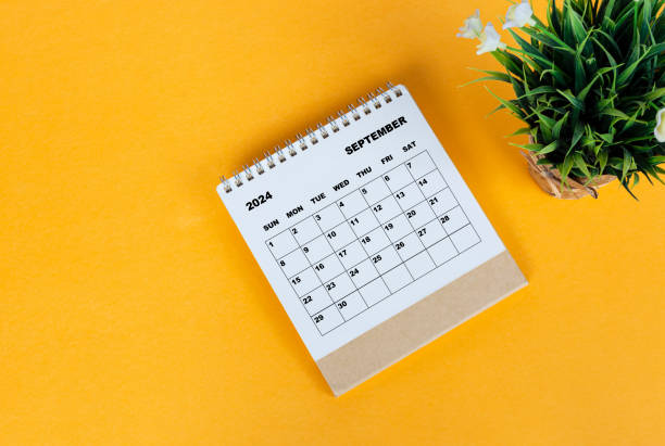 istock September 2024 desk calendar on yellow background. Directly above. Flat lay. 1761645423