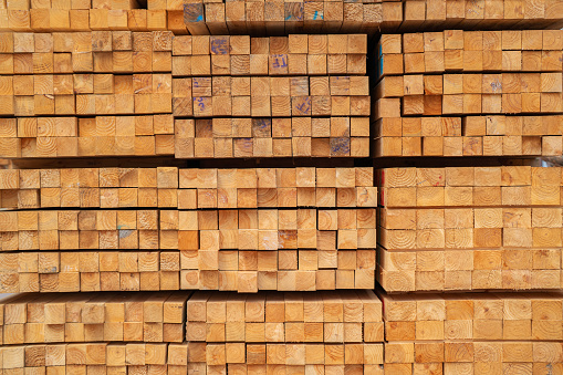 Displays arrangement of wooden bars, skillfully cut and stacked in perfect alignment. These wooden bars, awaiting their transformation into pallets, reflect the precision and dedication of the manufacturing process.