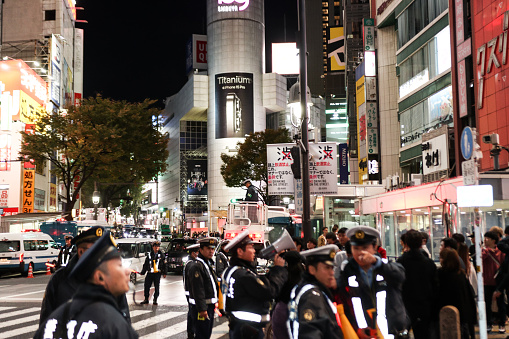 Police officers control pedestrian traffic as people cross the street during the Shibuya Halloween event on October 28, 2023 in Tokyo, Japan. It was the first time after four years that the festival was held due to the COVID-19 pandemic.