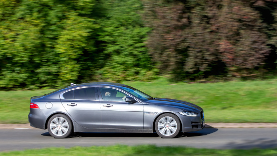 Milton Keynes,UK - Oct 28th 2023: 2015 grey diesel engine jaguar XE car driving on an English road