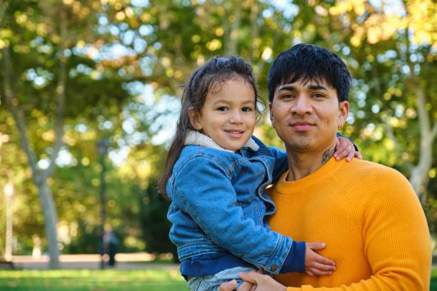 istock Happy Ecuadorian father holding his son in a park. 1761659032