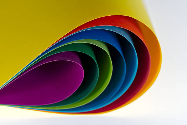 istock Scenic view of nested colorful papers lying on white illuminate background. 1761659573