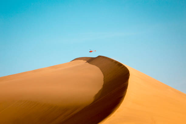 istock Helicopter Hovers over a mountain of sand 1761660118