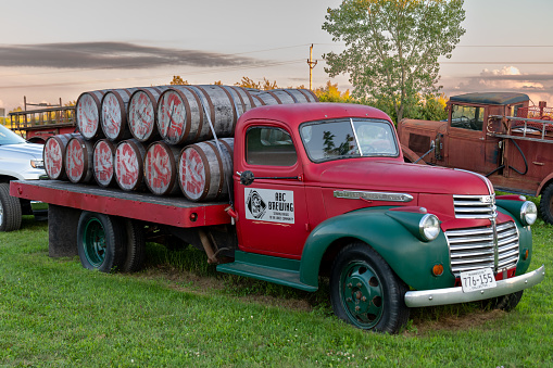 Battle Lake, Minnesota, USA July 23, 2022 Vintage truck with barrels of beer in it one evening in rural Minnesota, United States.