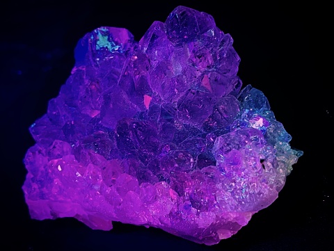 A purple crystal glows in the darkness
