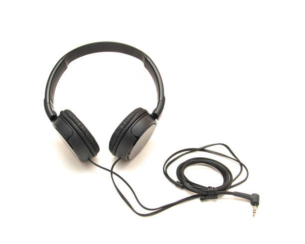 istock Side view black wired headphone with swiveling earcup foam cushions, L-shaped stereo mini plug 3.5mm isolated on white background, corded kids headphones dome type 1761675545