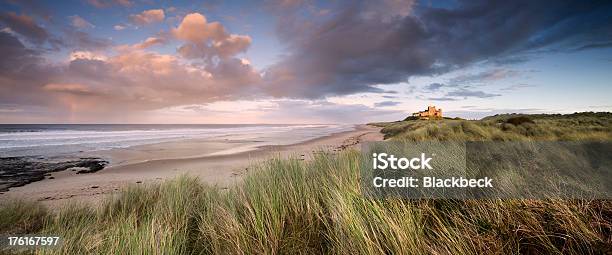 Beautiful Landscape And Clouds In Bamburgh Castle At Sunset Stock Photo - Download Image Now