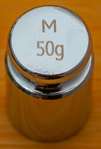 small 50g weight in cylindrical shape for calibrating precision scales