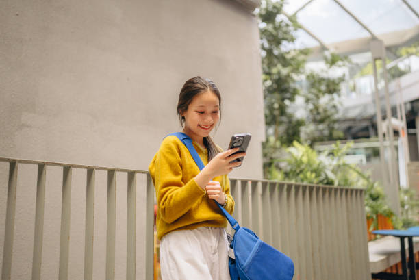 istock Asian woman university student using laptop 1761679878