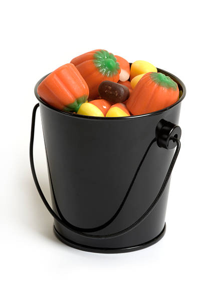 istock Halloween candy in black pail on white background 176168025