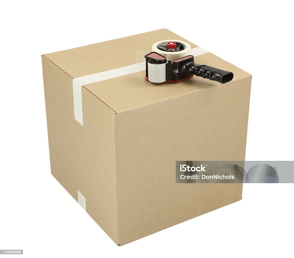 Cardboard Box and Tape Gun "Closed cardboard box and tape gun, isolated on white.Please also see my lightbox:" Adhesive Tape Stock Photo