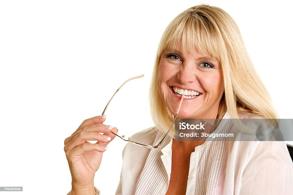 Blond Woman Holding Her Glasses Smiling A beautiful woman who is forty is holding her glasses and smiling at the camera on a white background.For more fabulous women in their forties please visit my lightbox 35-39 Years Stock Photo