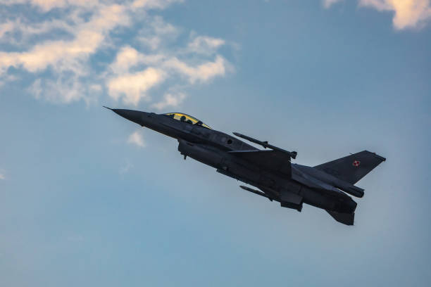 Antidotum Airshow Leszno 2023 and acrobatic shows full of smoke of F-16 Tiger Demo Team on a cloudy sky Leszno, Poland - June 17 2023: Antidotum Airshow Leszno 2023 and acrobatic shows full of smoke of F-16 Tiger Demo Team on a cloudy sky f 16 demo team stock pictures, royalty-free photos & images