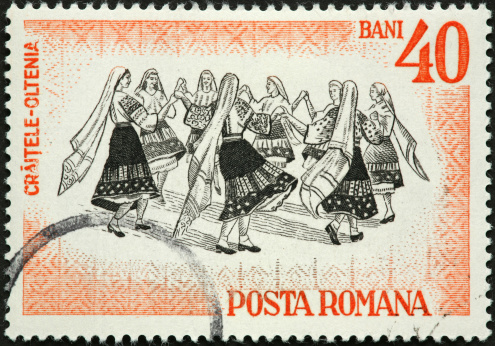 Romanian folk dancing women in traditional dress.