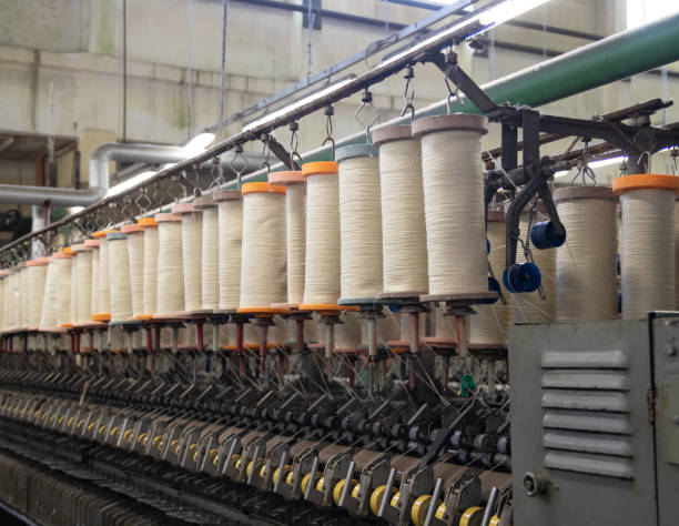 istock large bobbins of flax threads for fabrics .Flax processing plant, fabric production. Flax is made .A workshop at a textile factory. 1761725749