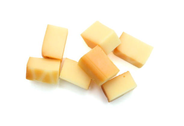 istock Cubes of cheddar cheese isolated on white 1761731824