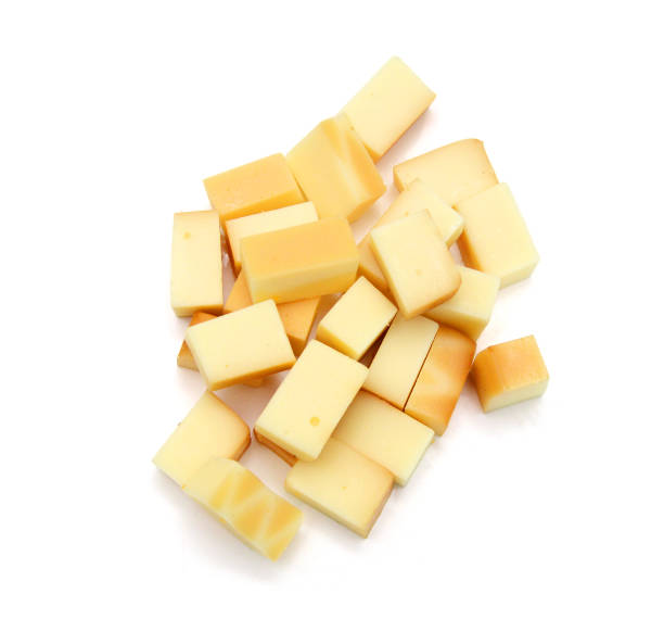 istock Cubes of cheddar cheese isolated on white 1761732966