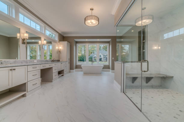 White bathroom with transom windows above vanity Lots of room in bathroom for spacious showering, bathing with a view and getting ready for the day or brushing your teeth Home Remodeling .