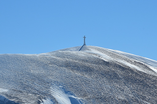 The summit cross of Mount Catria on a cold winter day, Marche region, Italy