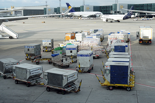 Various Airfreight Cargo Containers on the tarmack at Frankfurt Airport (FRA / EDDF) in Germany. In the background you can see a Lufthansa Airbus A380-800 and an Airbus A320NEO. The photo was taken on October 25, 2019.