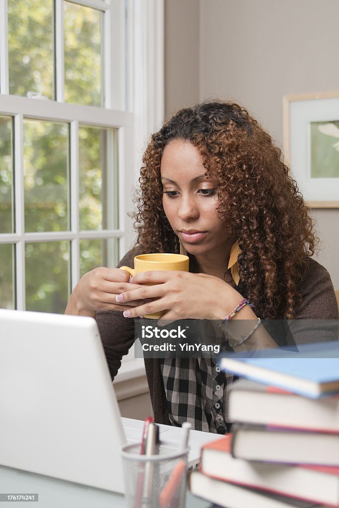 Portrait of Young Black Female Teen Student Studying Vt Subject: A young black female teen student studying in her room. 18-19 Years Stock Photo