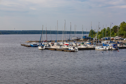 Smardzewice, Poland - June 9 2023: Small bay full of boats and ferries at coast of big lake at sunny morning