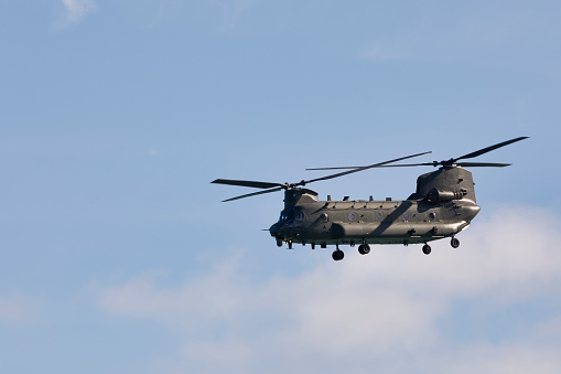 Black Hawk Military Helicopters flying over sea at sunset