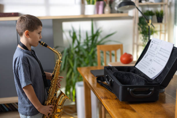 istock Little musician playing saxophone 1761784630