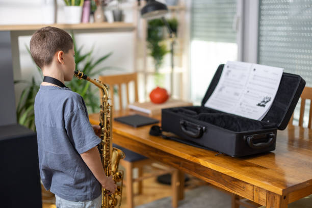 istock Little musician playing saxophone 1761784649