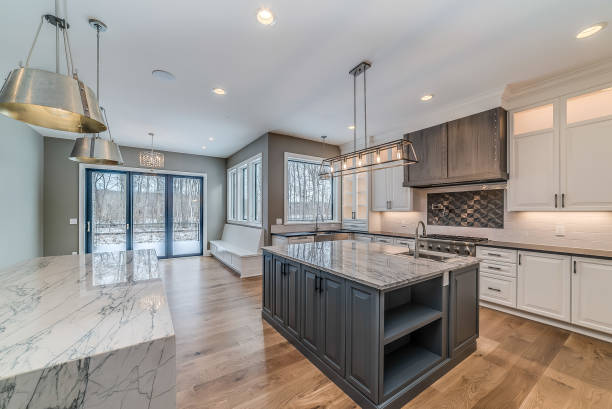 istock Large kitchen with island surrounded by white quartzite countertops 1761797029