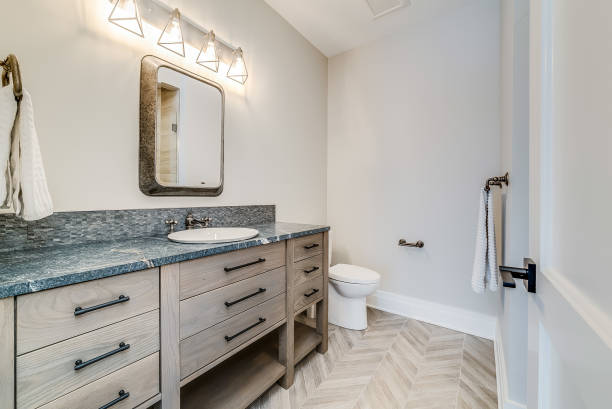 istock Small square mirror and vanity lighting in bathroom 1761798092