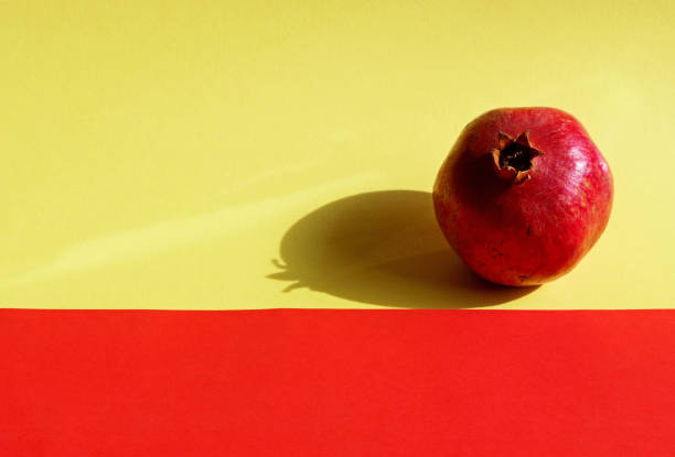 istock a pomegranate on colorful background 1761799846