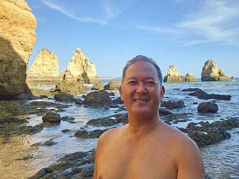 Selfie at Algarve's rocky beach in Portugal