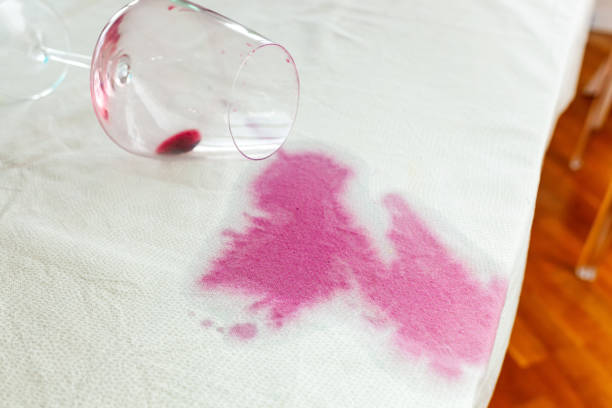 istock Spilled wineglass with a red spot on tablecloth 1761843059