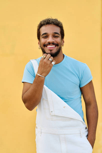 istock Latin young man smiling at camera with hand on chin 1761864221