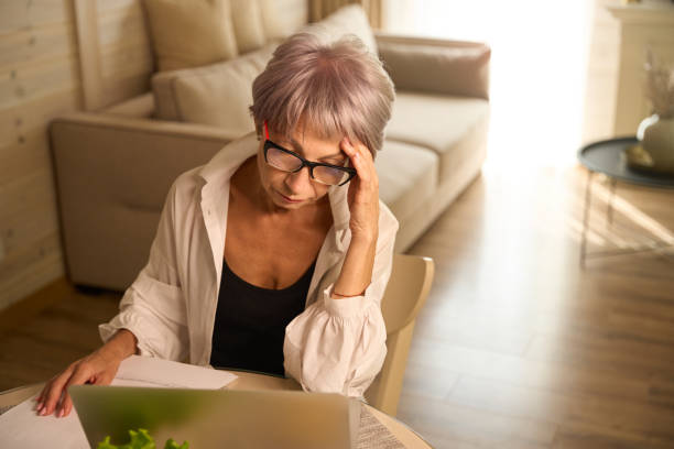 istock Woman with glasses works remotely in her kitchen 1761872317