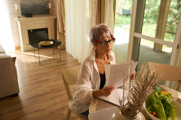 istock Female works remotely in her kitchen with work papers 1761872320