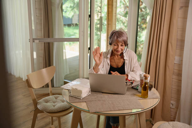 istock Nice older female chats online in her kitchen 1761872342