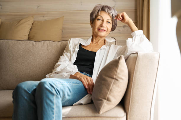 istock Beautiful elderly lady is relaxing on a cozy sofa 1761872380