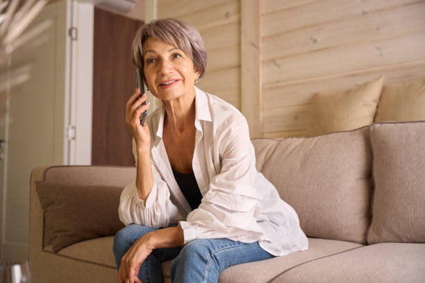 istock Beautiful lady in casual clothes communicates on her mobile phone 1761872896
