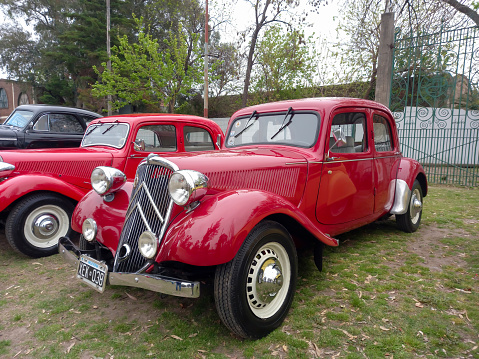 Lanús, Argentina - Sept 23, 2023: old red elegant 1946 Citroen Traction Avant 11 Legere on the lawn. Classic car show