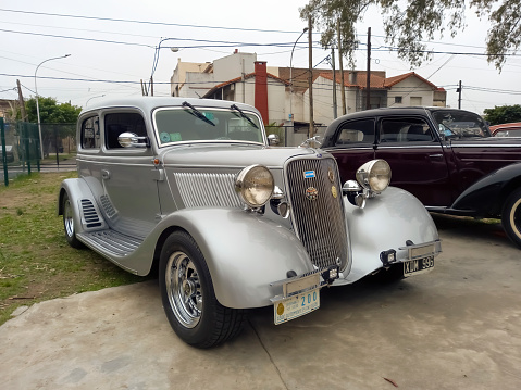 Lanús, Argentina - Sept 23, 2023: Old silver gray 1933 Ford Model 40 V8 Victoria Tudor sedan hot rod at a classic car show.