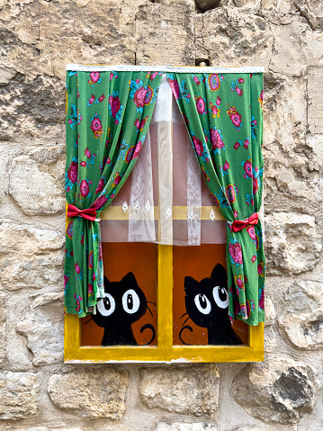09/30/2023,Mardin,Türkiye,Old window decorated with paints, On a street in the old town of Mardin